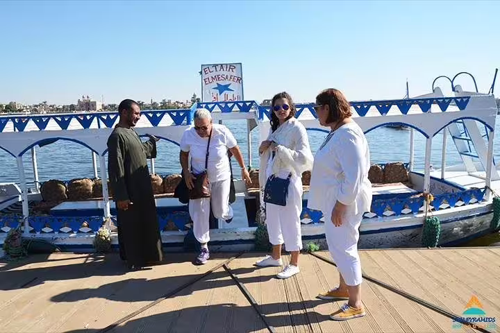 Tourists boarding a felucca on the Nile in Luxor, Egypt, for a scenic private sailing ride and sunset cruise