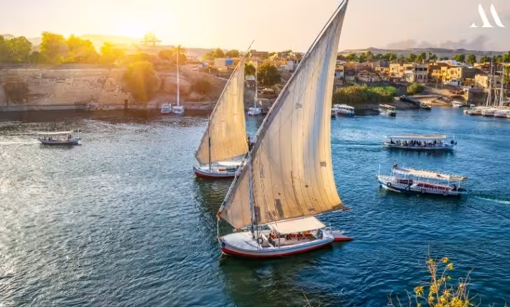 Felucca sailboat cruising the Nile at sunset in Aswan, Egypt, on a 15-day Red Sea to Pharaohs tour