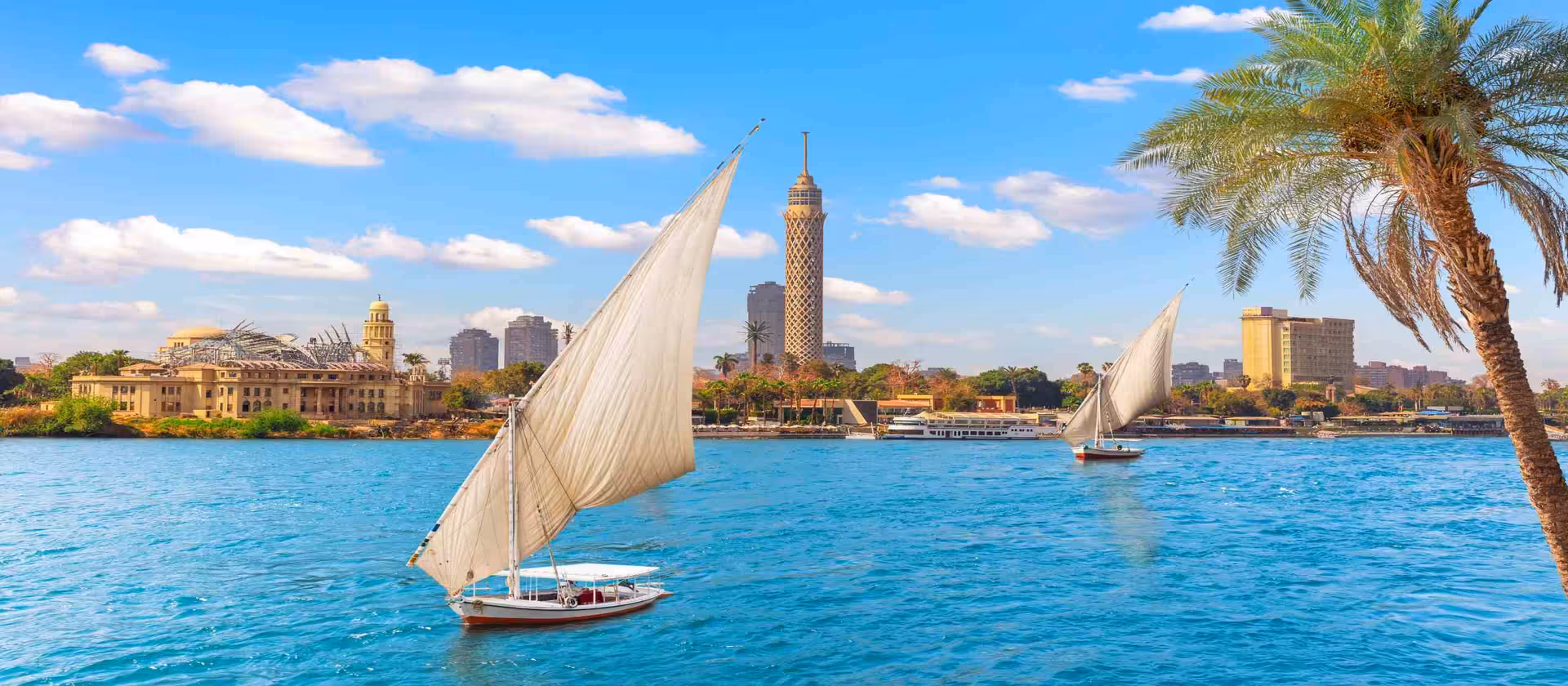 Felucca sailboats on the Nile in Cairo with skyline views, classic river experience on the Ultimate Egyptian Odyssey