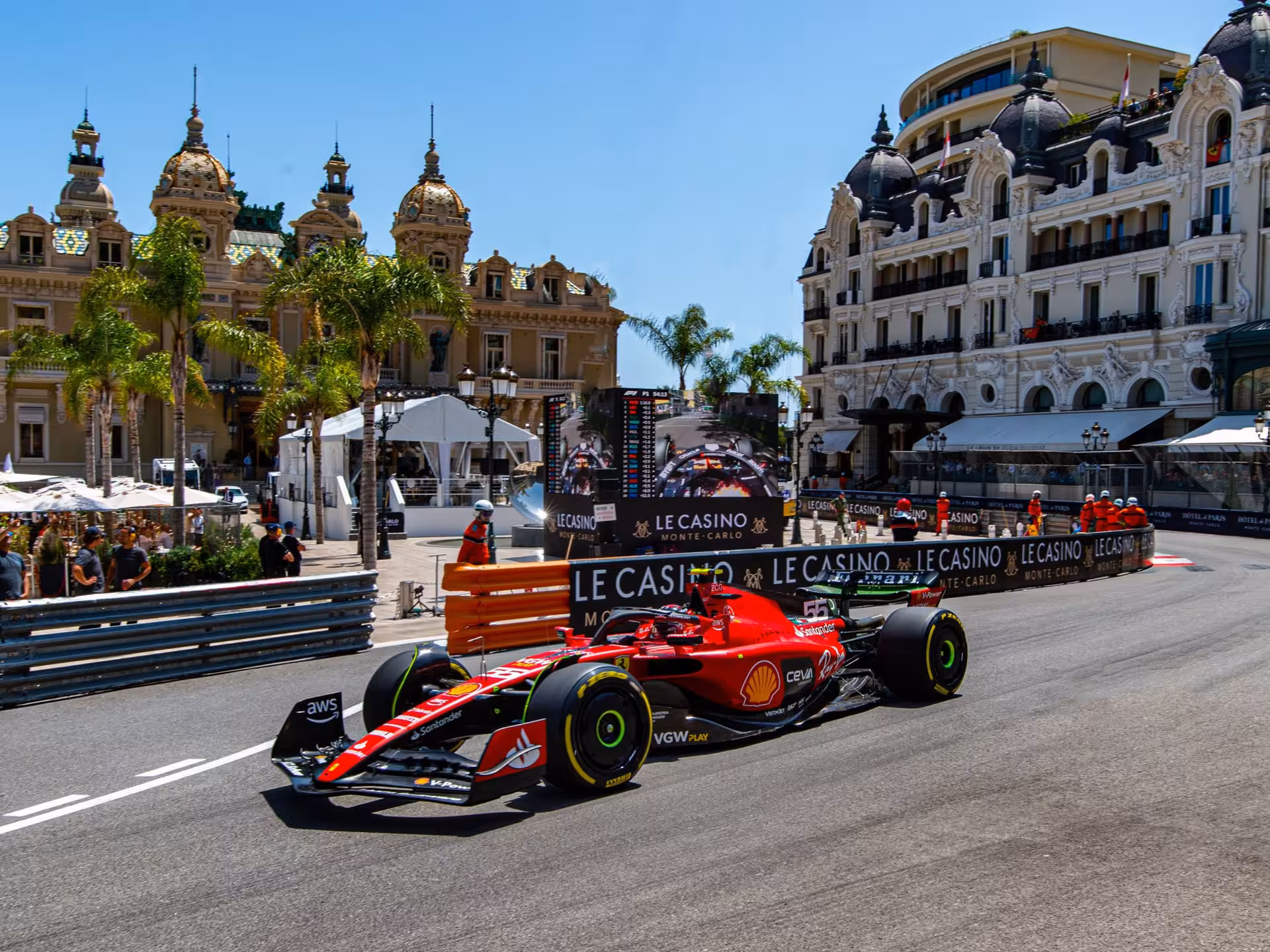 Ferrari F1 car racing past Le Casino Monte-Carlo during Monaco Grand Prix on street circuit