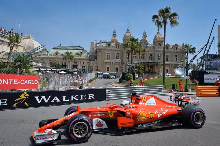 Ferrari Formula 1 car racing through Monaco Monte Carlo street circuit with Casino in background