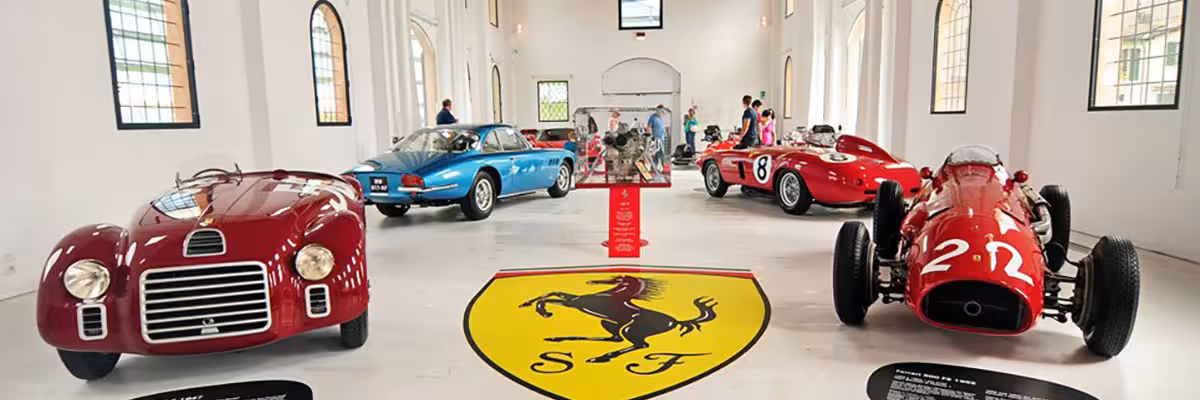Classic Ferrari race cars on display inside Maranello museum, part of Modena combo ticket plus Mirabilandia entry