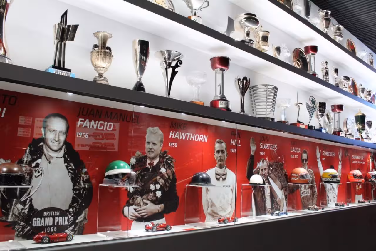 Ferrari museum trophy wall with F1 champions and helmets, included in Lamborghini Ducati Ferrari Museums combo