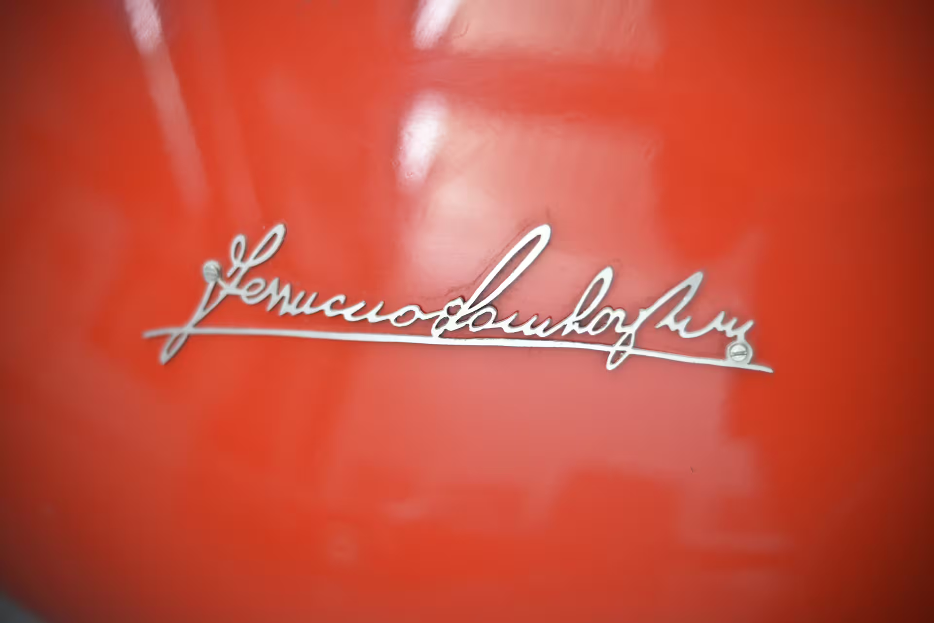 Close-up of Ferruccio Lamborghini signature badge on red exhibit, Ferruccio Lamborghini Museum Bologna ticket