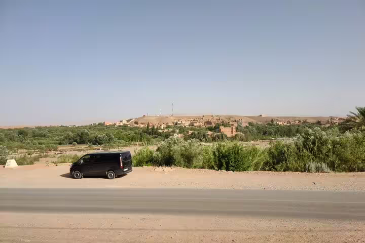 Private 3-day desert tour from Fes to Marrakech van crossing a lush oasis valley in southern Morocco