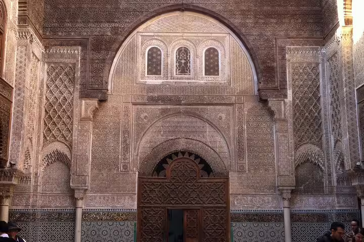 Intricate carved stucco and zellige archway in Fes medina, Morocco, on Your Own Morocco cultural tour
