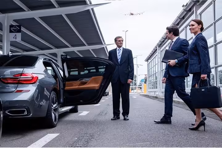 Business professionals preparing for a transfer from the airport to Fes or Marrakech in a luxury sedan.