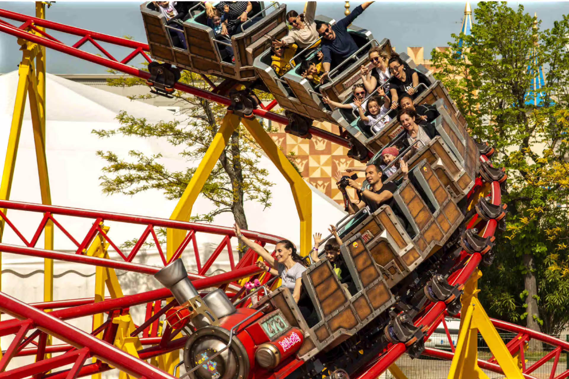 Family riding Fiabilandia roller coaster in Rimini, Italy, with entrance ticket for kids and adults