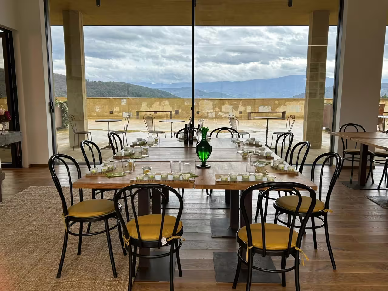 Olive oil tasting table at Frantoio Buonamici in Fiesole with Tuscan hills view during Olio EVO experience
