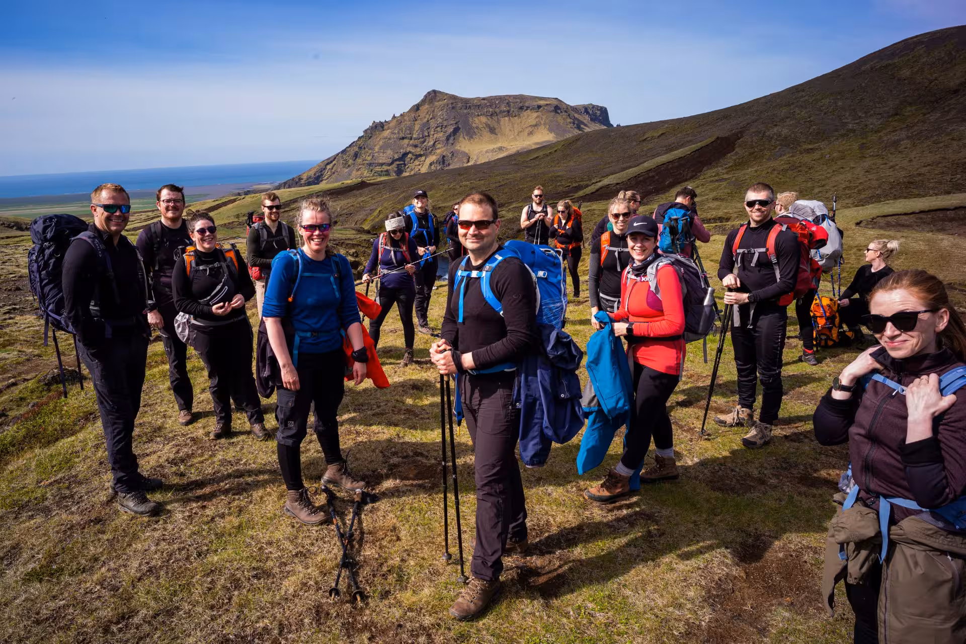 Group of hikers with backpacks and trekking poles on Fimmvorduhals trail in Iceland