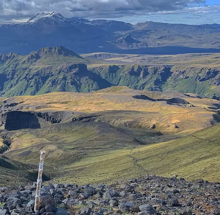 Panoramic view of green volcanic highlands and snow-capped mountains on Fimmvorduhals hike in Iceland
