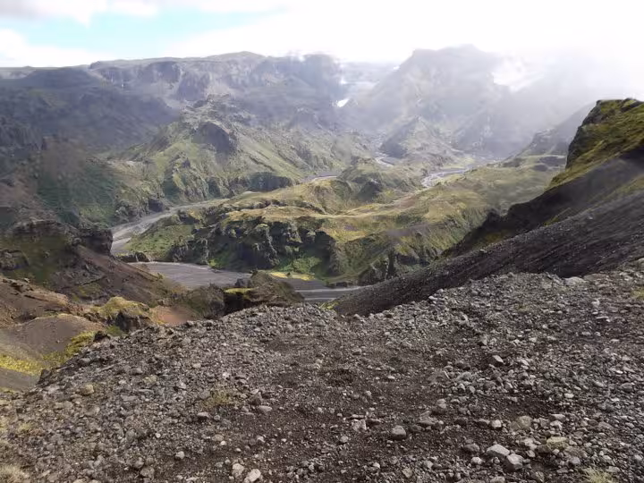 Panoramic view of a volcanic valley with green moss-covered mountains on the Fimmvorduhals hike in Iceland