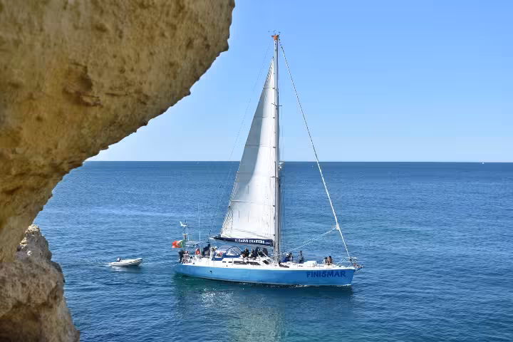 FINISMAR Yacht gliding on blue waters with sails up, offering a scenic 3-hour cruise along the Algarve coast.