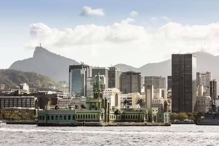 View of Fiscal Island and Rio's skyline with Sugarloaf Mountain from Guanabara Bay, perfect for a scenic boat tour.