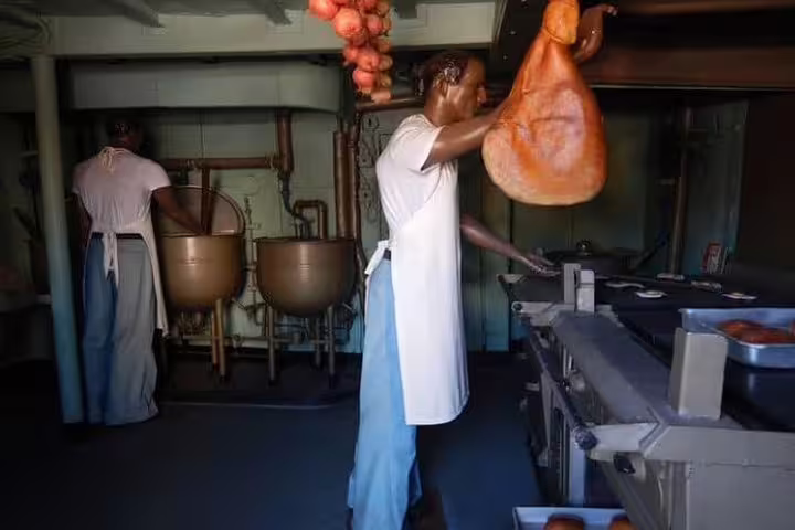 Historic kitchen scene on Fiscal Island, showcasing traditional cooking methods during the Brazil Imperial tour.