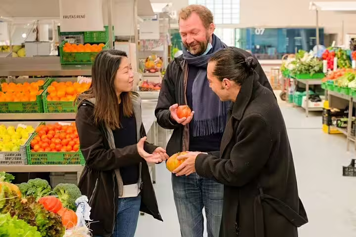 Tour participants enjoy a vibrant market experience, selecting fresh produce on the Only Fish Market Tasting Tour.