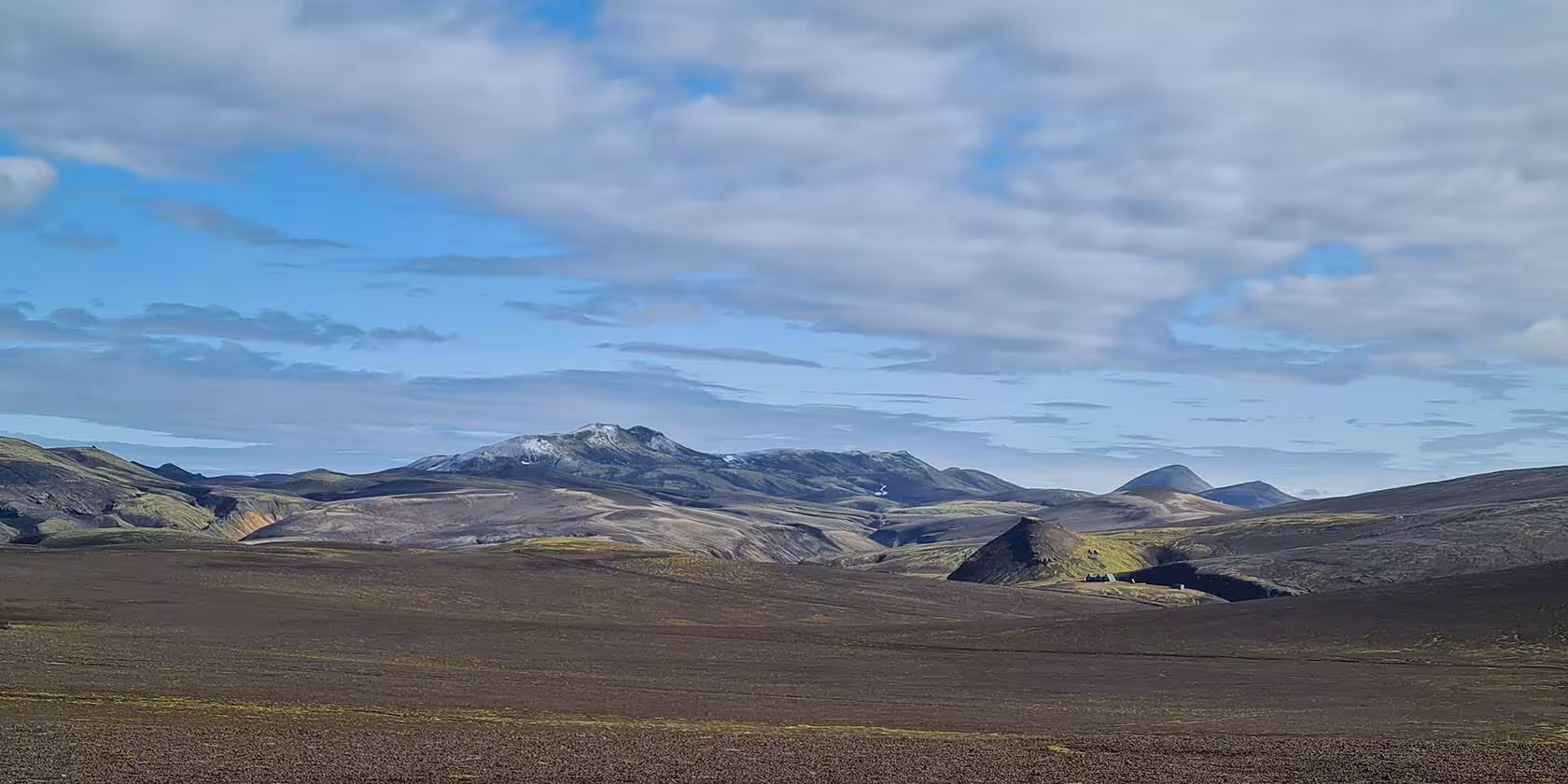Vast volcanic highland landscape with snow-capped mountains in Fjallabak Nature Reserve, Iceland