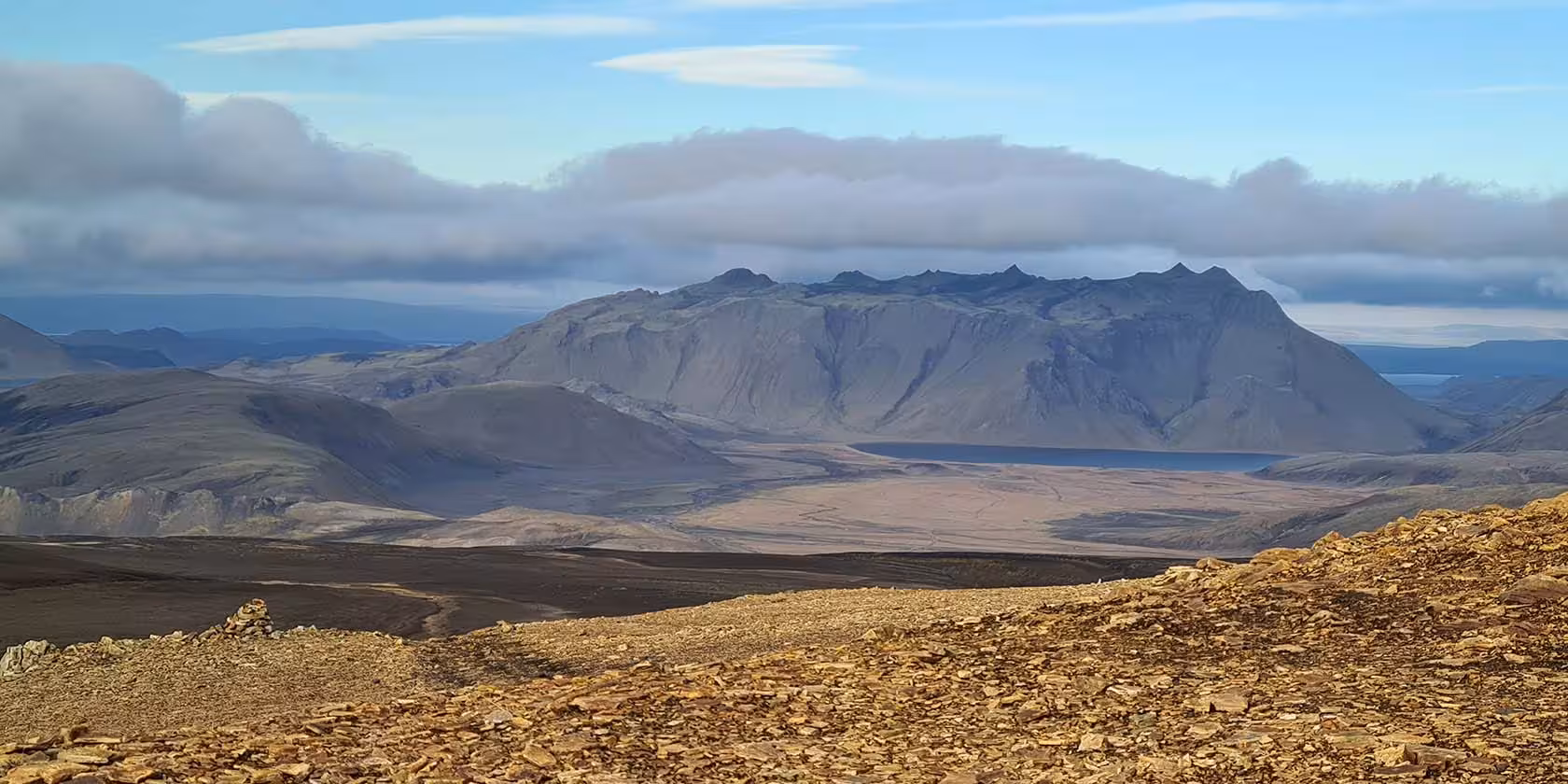 Panoramic view of rugged volcanic mountains and vast flat valley in Fjallabak Nature Reserve, Iceland