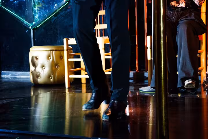 Close-up of flamenco dancer's feet mid-performance on a polished stage, capturing the rhythmic intensity in Barcelona.