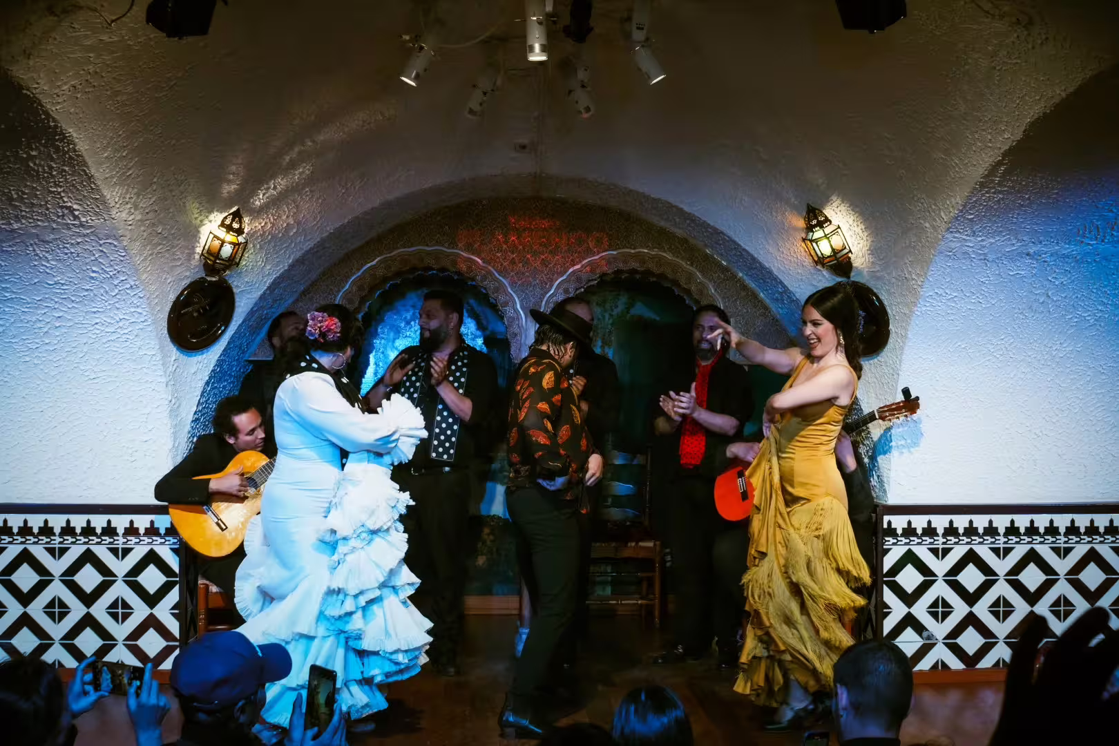 Vibrant flamenco dancers in colorful attire performing at Tablao Cordobes, La Rambla, Barcelona.