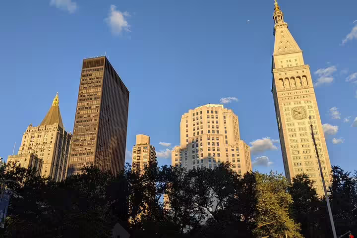 Flatiron NYC skyline with Met Life Tower clock tower and skyscrapers at golden hour
