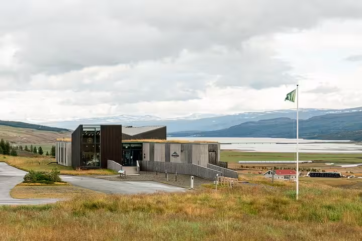Visitor center building in Fljótsdalur East Iceland with fjord and snow-capped mountains in background