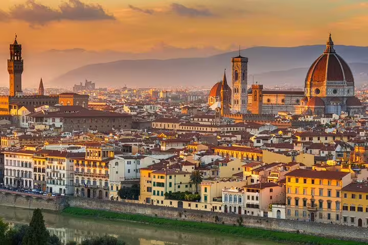 Scenic view of Florence city skyline at sunset, highlighting iconic architecture for airport transfers.