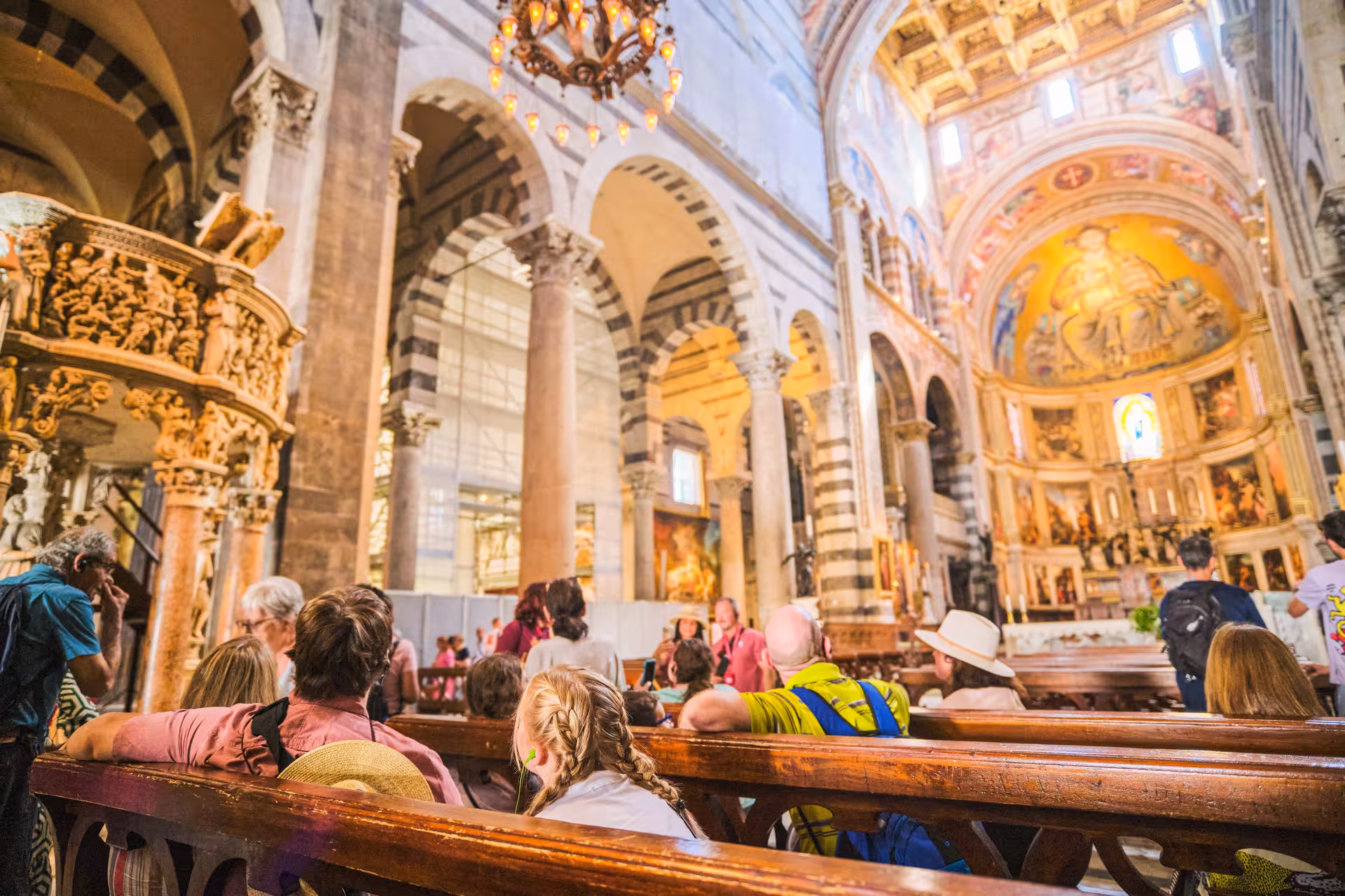 Visitors admire the ornate interior of a historic cathedral in Florence on a guided shore excursion.