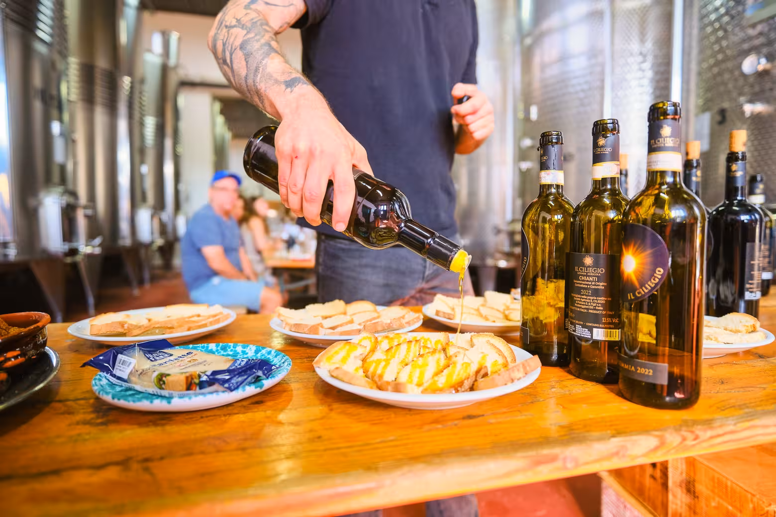 Wine being poured over bread in an Italian winery during Florence to Chianti wine tasting tour.