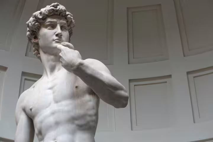 Close-up of the iconic marble David statue in Florence, a highlight of private excursions from Livorno with museum visit