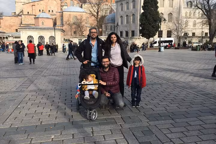 Family photo in historic square during Florence day trip from Rome, exploring landmarks and city center