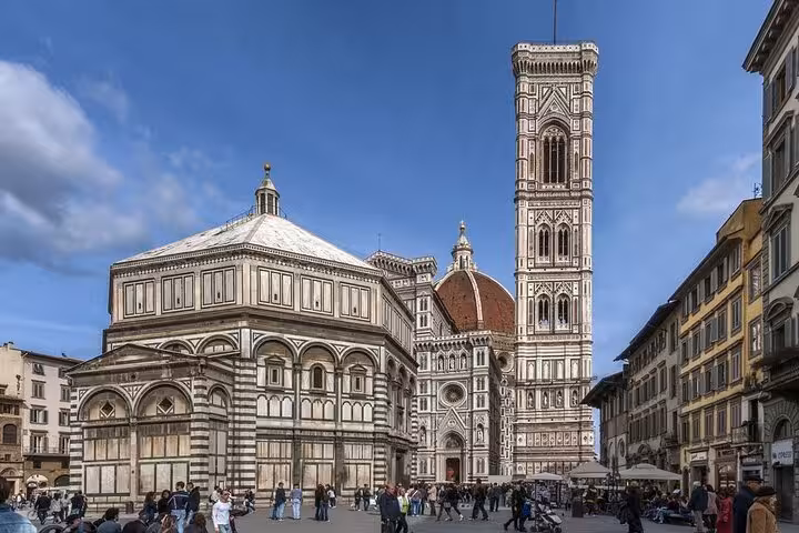 Discover Florence's iconic Duomo and Baptistery with vibrant architecture on a day trip from Rome.