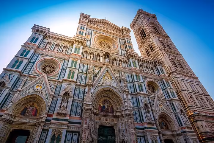 Close-up of Florence's stunning Duomo facade, showcasing intricate designs and Renaissance artistry.