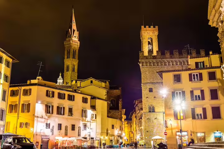 Florence medieval towers and historic buildings illuminated at night near Dante's neighborhood