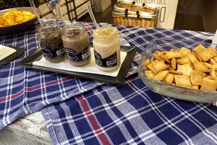Tuscan truffle paste jars with crackers on a checkered cloth during a Florence street food tasting tour