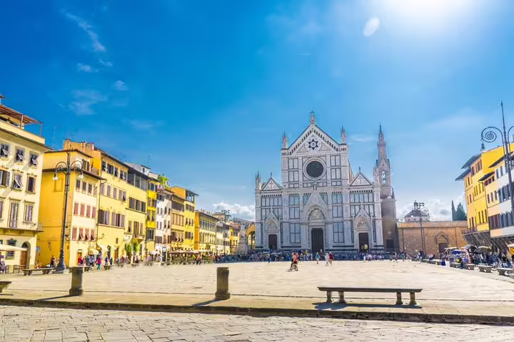 Piazza Santa Croce with the iconic white marble basilica facade in Florence, Italy on a sunny day
