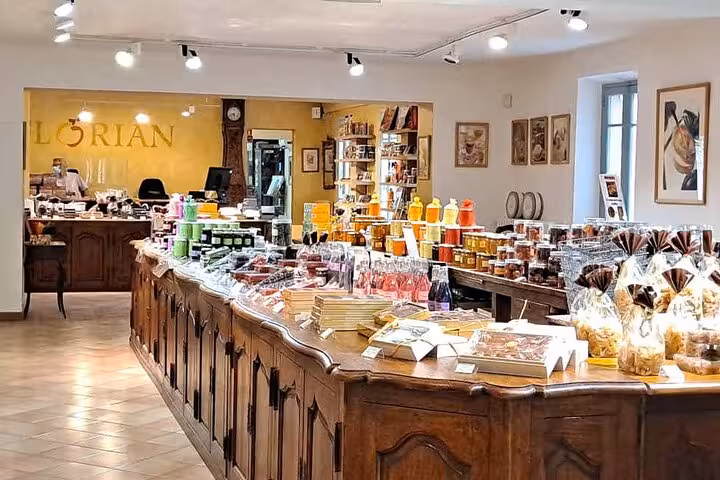 Interior of Florian confectionery shop on the French Riviera with colorful candies and jams on wooden counters