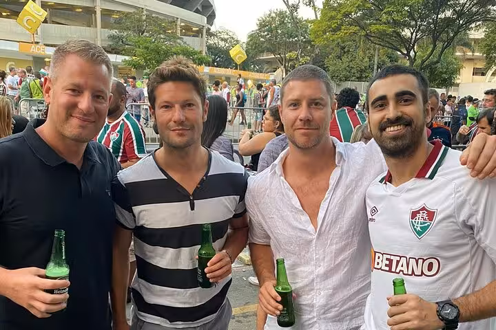 Fluminense fans with drinks outside Maracanã Stadium before a Rio de Janeiro soccer match experience