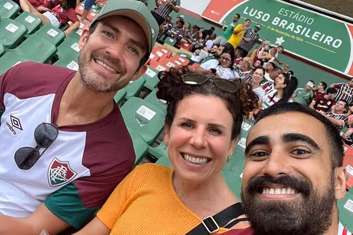 Tour guests selfie at Maracanã for Fluminense match, Rio de Janeiro football experience with stadium seats behind