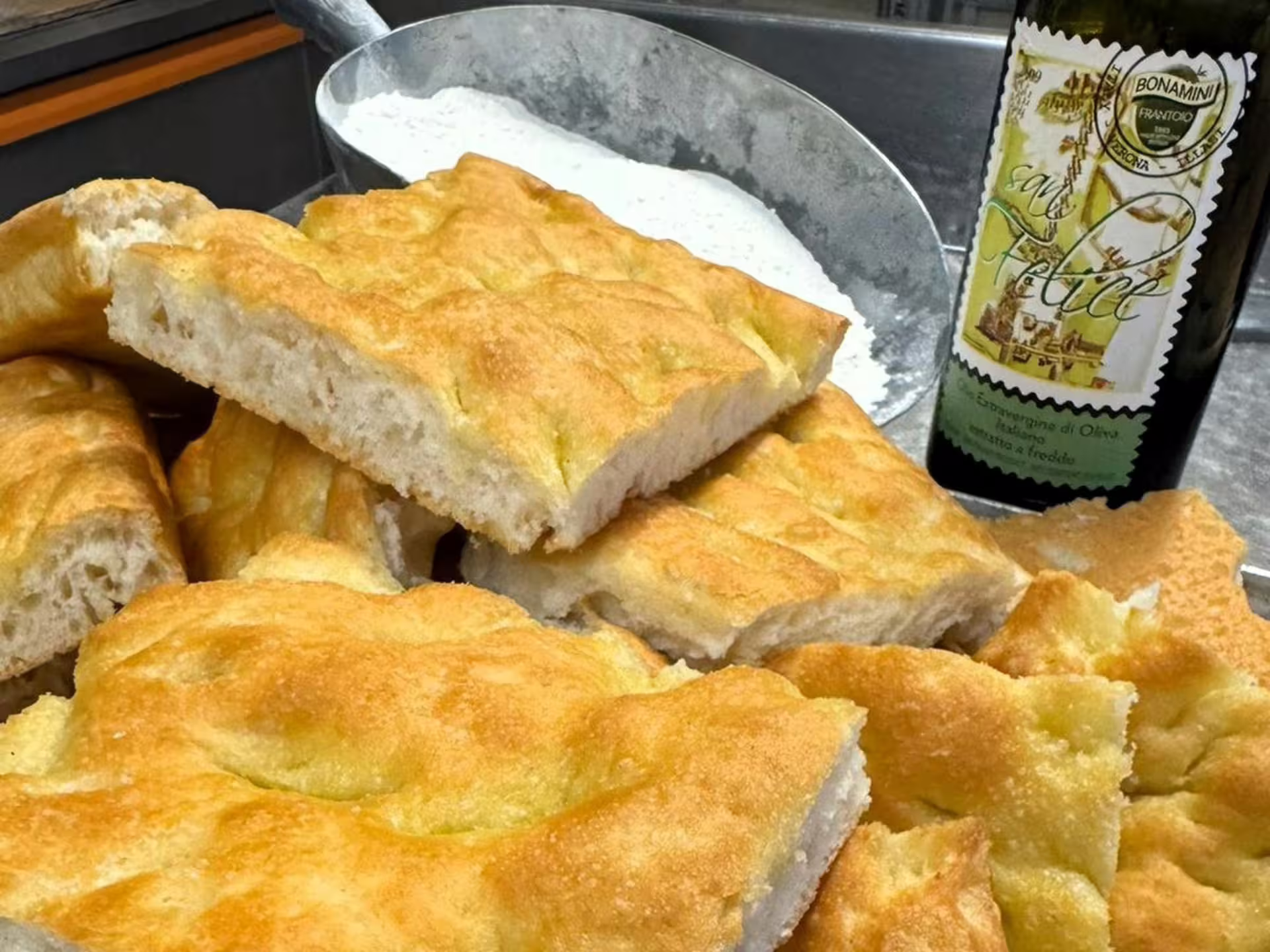 Focaccia bread and local extra virgin olive oil served for tasting on Verona countryside olive mill tour
