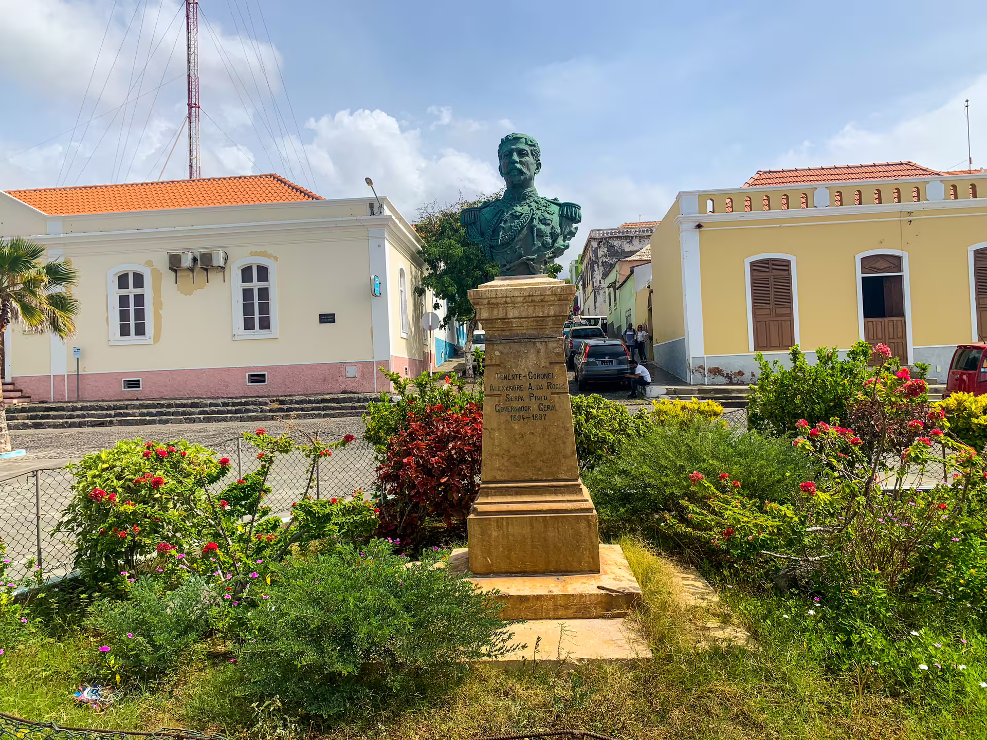 Historic statue in a vibrant garden setting on Fogo Island, offering cultural insights during the full-day private tour.
