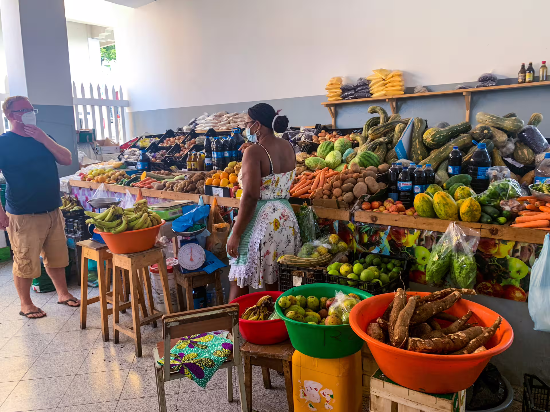 Local market scene on Fogo Island with fresh produce and friendly interaction, showcasing authentic Cape Verdean culture.