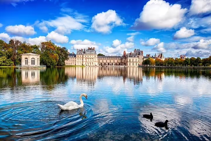 Fontainebleau Castle and lake with swan, scenic view on half-day tour from Paris, France day trip