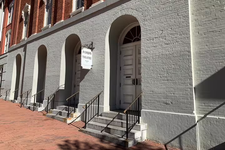 Ford's Theatre historic gray brick exterior with arched doorways and entrance steps, Washington DC