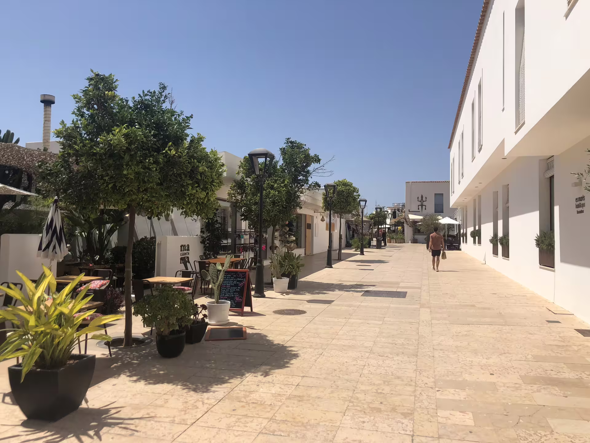 Quiet Formentera village street with white buildings, ideal stop on Ibiza to Formentera bike day trip with ferry