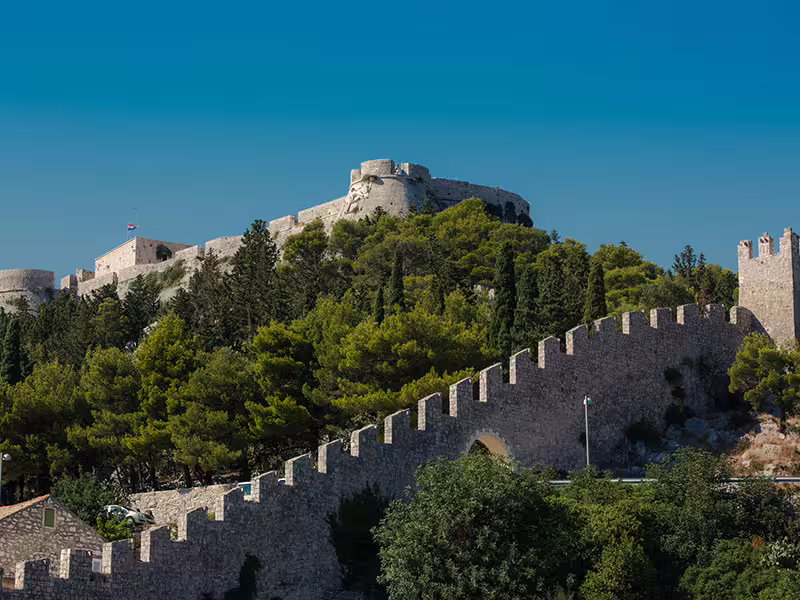 Fortica Fortress above Hvar Town with stone walls and pine forest, sightseeing on Vis and Blue Cave tour