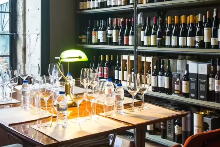 Fortified wine tasting setup with glassware and bottles in a cozy cellar, perfect for discovering diverse wine flavors.