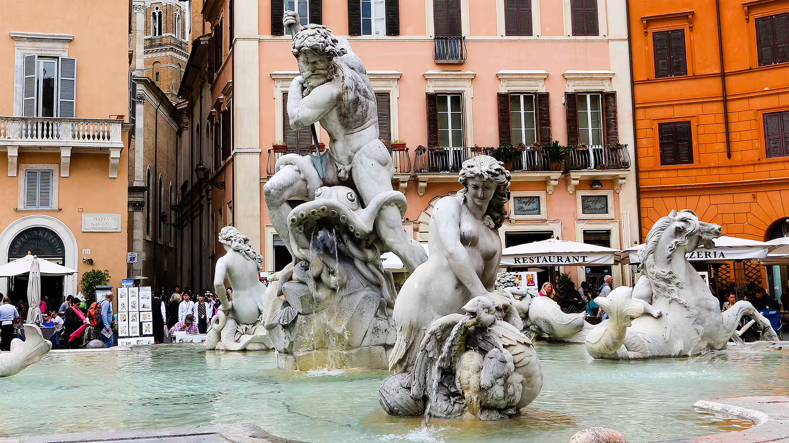 Tourists admire the ornate Fountain of Neptune in Piazza Navona on a semi private walking tour through baroque Rome landmarks