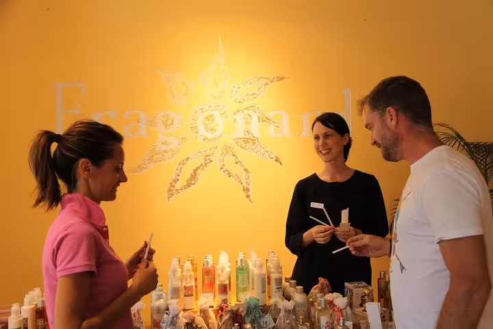 Tourists sampling perfumes at Fragonard boutique on French Riviera tour from Monaco