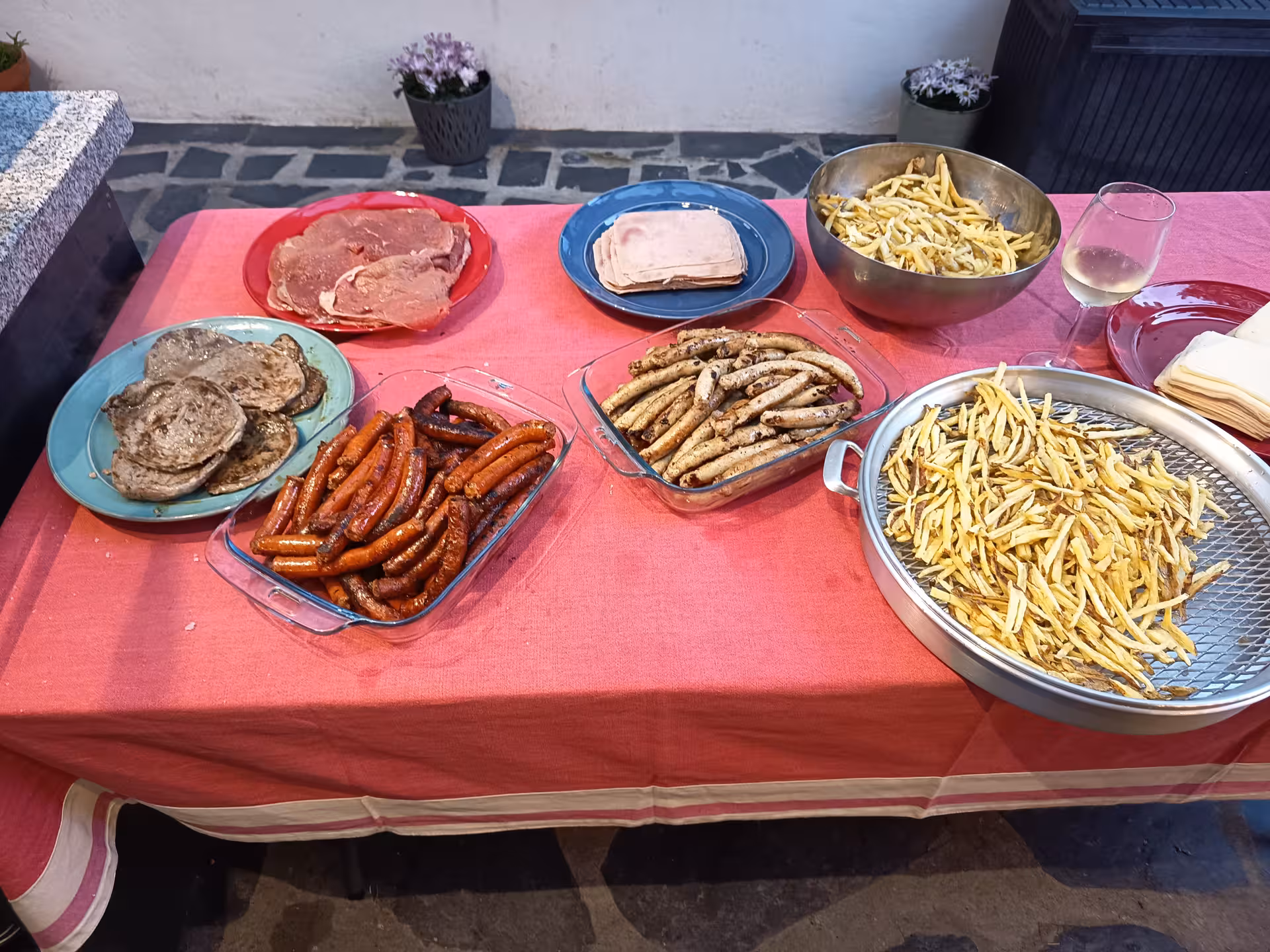 Variety of fresh ingredients including sausages, meats, and fries for making Francesinha in Porto culinary tour.